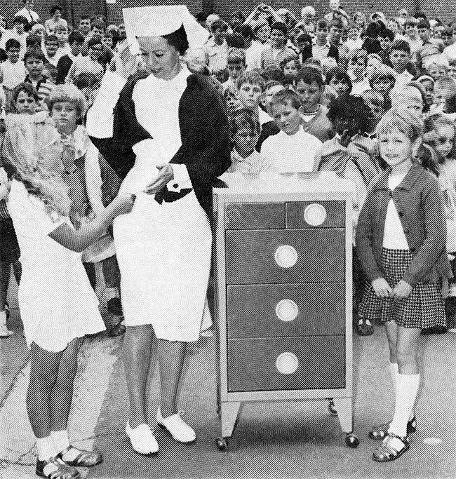 Senior Sister Miss Margaret Eardley receives a $50 donation in 1969 from pupils at Sunshine State School for the purchase of a bedside locker.