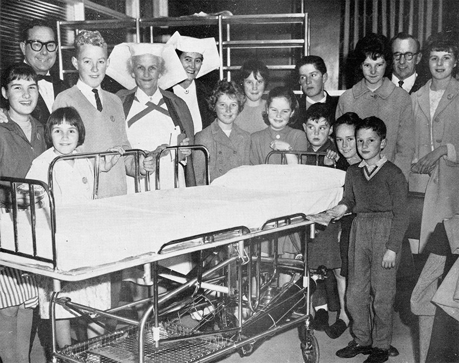 The Hospital Jays, a children’s auxiliary, present a resuscitation trolley valued at £150 to the hospital in 1963. From left to right: Linda and Alfred Crusius, Mr Leyton Caudwell, Ken Pannell (founder of the Jays), Matron Mavis Mitchell, Deputy Matron J. Alexander, June Dunn, Janet Messenger, Maree Thompson, Robert Thompson, Frank Thompson, Len Sheppard, Grant Hammid, Geraldine Cunningham, Marlene Barlow and Mr Eric Farnsworth. About 160 children were members of the Hospital Jays in 1963.